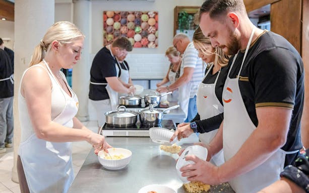 Participants making pasta in a Florence cooking class.