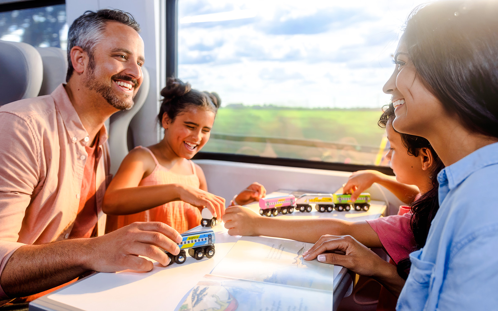 Family enjoying a train ride on the Brightline from Miami to Orlando.