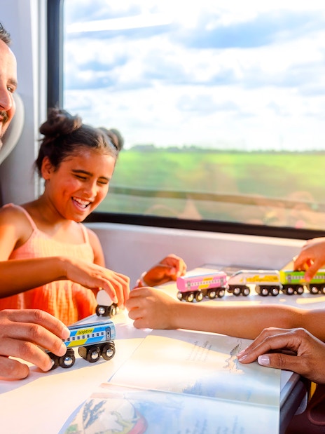 Family enjoying a train ride on the Brightline from Miami to Orlando.