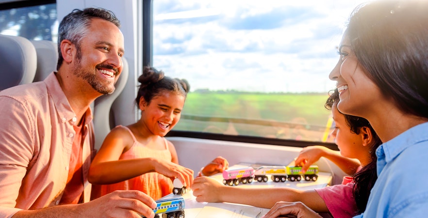 Family enjoying a train ride on the Brightline from Miami to Orlando.