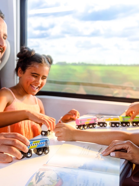 Family enjoying a train ride on the Brightline from Miami to Orlando.