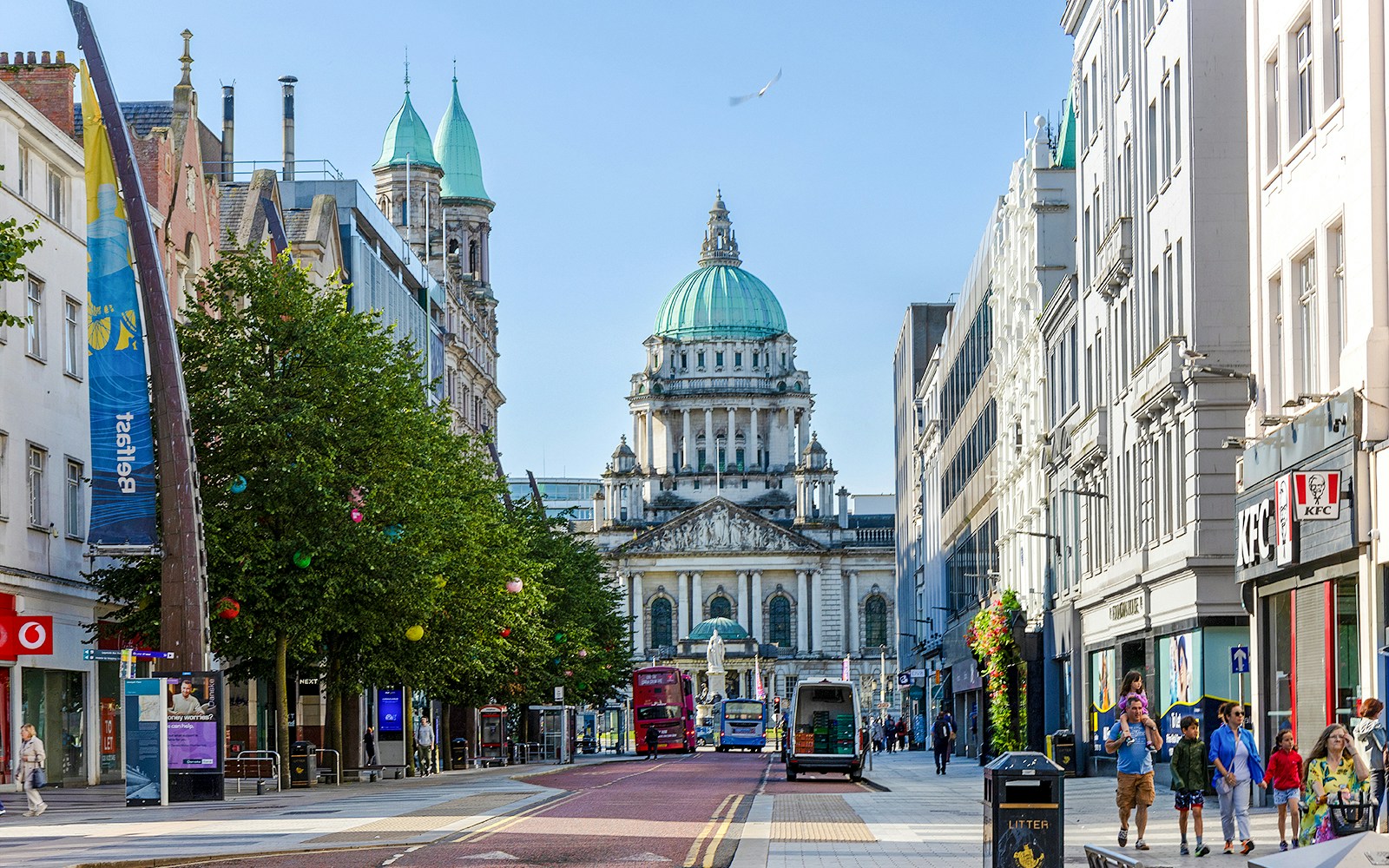Belfast City Hall with surrounding street and people walking.