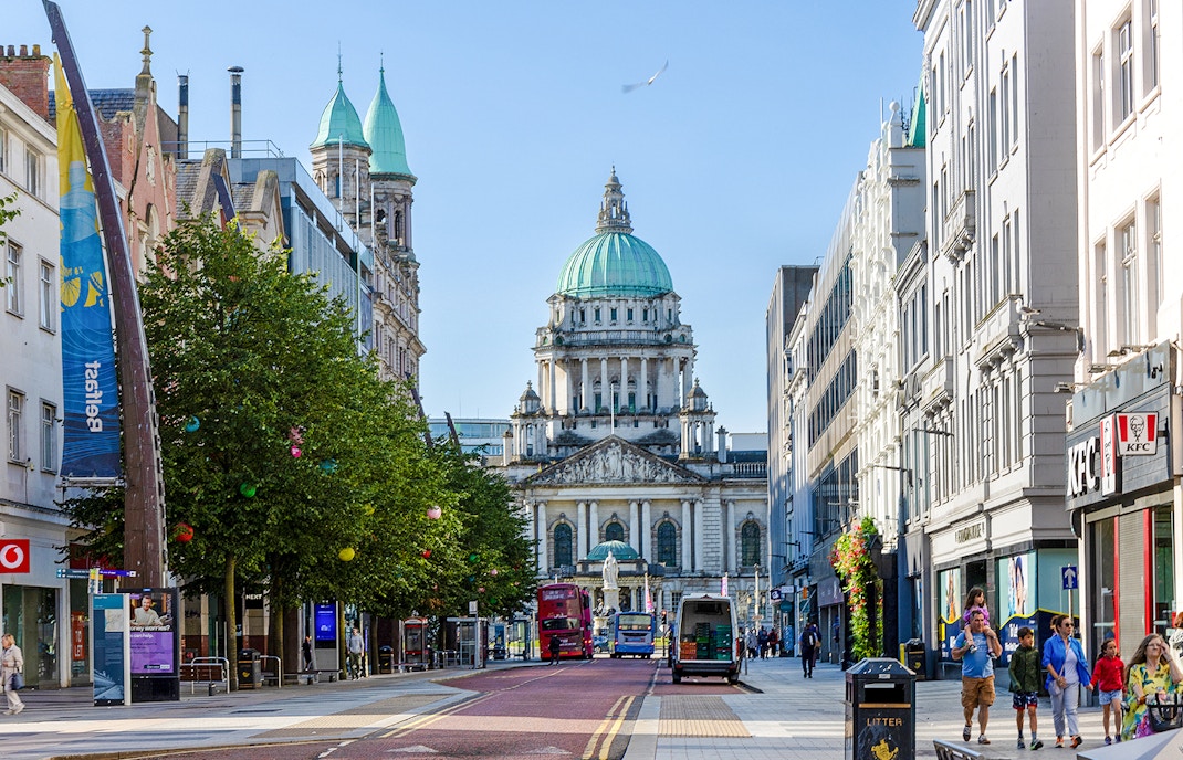 Belfast City Hall with surrounding street and people walking.