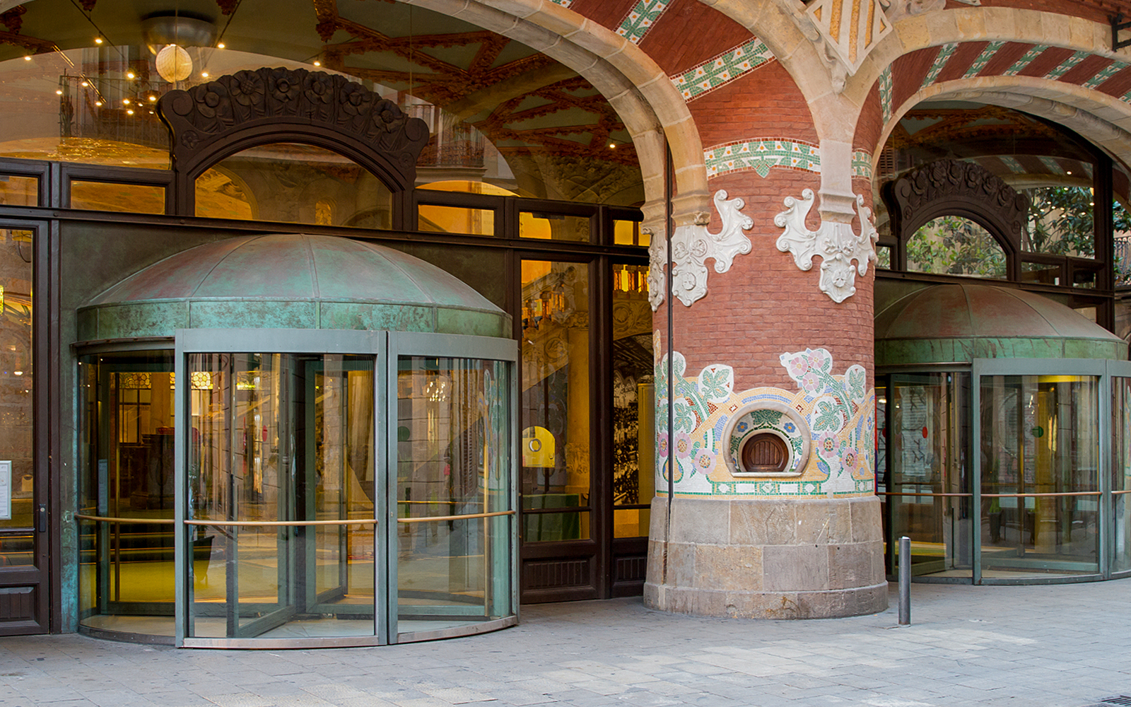 Entrance of Palau de la Música Catalana with ornate mosaic columns in Barcelona.