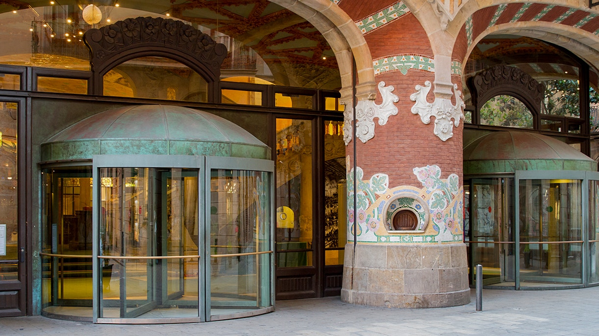 Entrance of Palau de la Música Catalana with ornate mosaic columns in Barcelona.