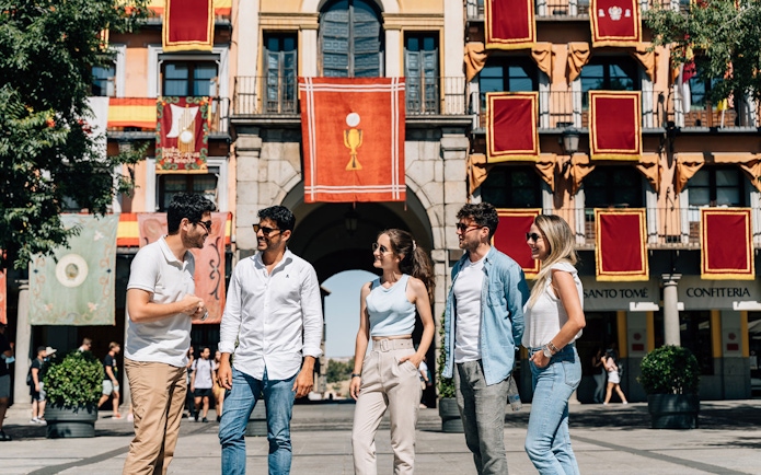 Tourist group with guide exploring Toledo's historic attractions.