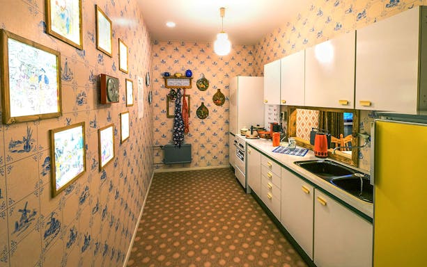 DDR Museum Berlin kitchen exhibit with vintage decor and appliances.