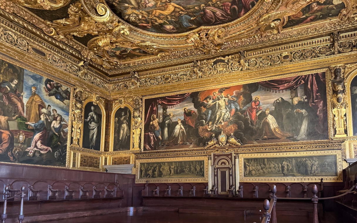 Doge's Palace interior with ornate ceiling and historic paintings, Venice.