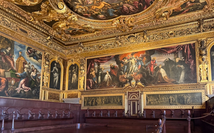 Doge's Palace interior with ornate ceiling and historic paintings, Venice.
