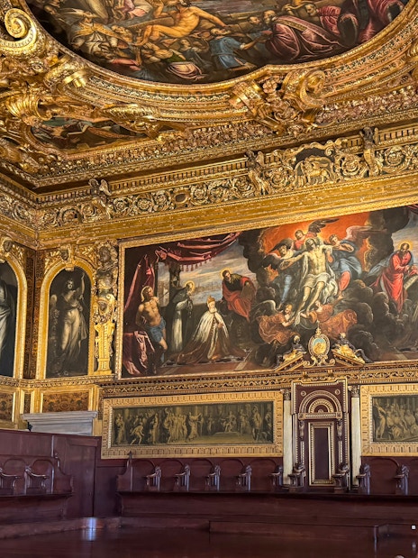 Doge's Palace interior with ornate ceiling and historic paintings, Venice.