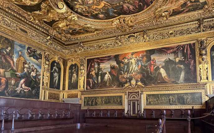 Doge's Palace interior with ornate ceiling and historic paintings, Venice.