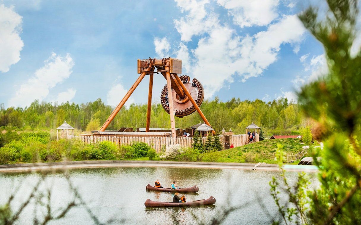 Belantis Adventure Park ride with canoes on a lake in the foreground.
