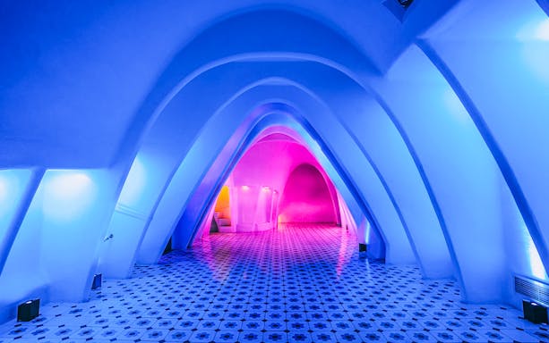 Casa Batlló interior with colorful arches and tiled floor, Barcelona.