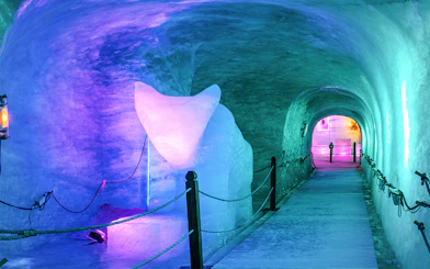 Ice tunnel illuminated with colorful lights on the Mer de Glace train ride, Chamonix Mont Blanc.