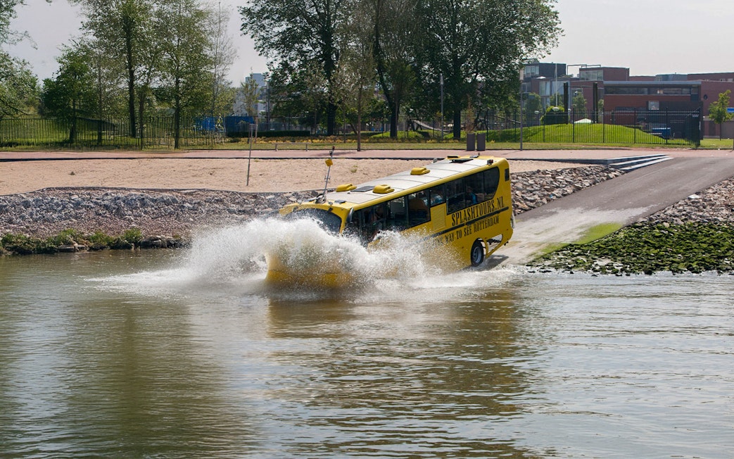 Amphibious bus entering water during 1-hour sightseeing tour in Rotterdam.