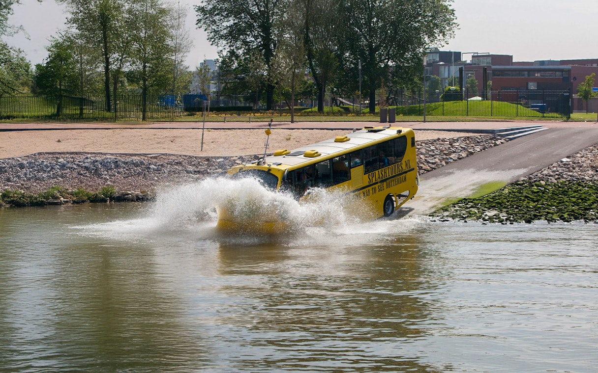 Amphibious bus entering water during 1-hour sightseeing tour in Rotterdam.