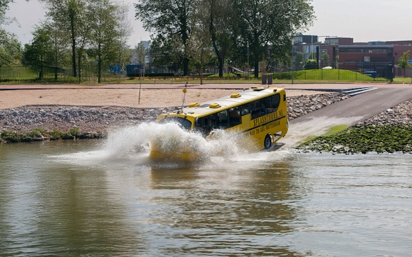 Amphibious bus entering water during 1-hour sightseeing tour in Rotterdam.