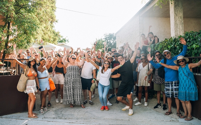 Group of tourists enjoying Krka Waterfalls tour and wine tasting near Split.