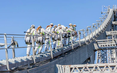 Climbers ascending Story Bridge in Brisbane during adventure tour.