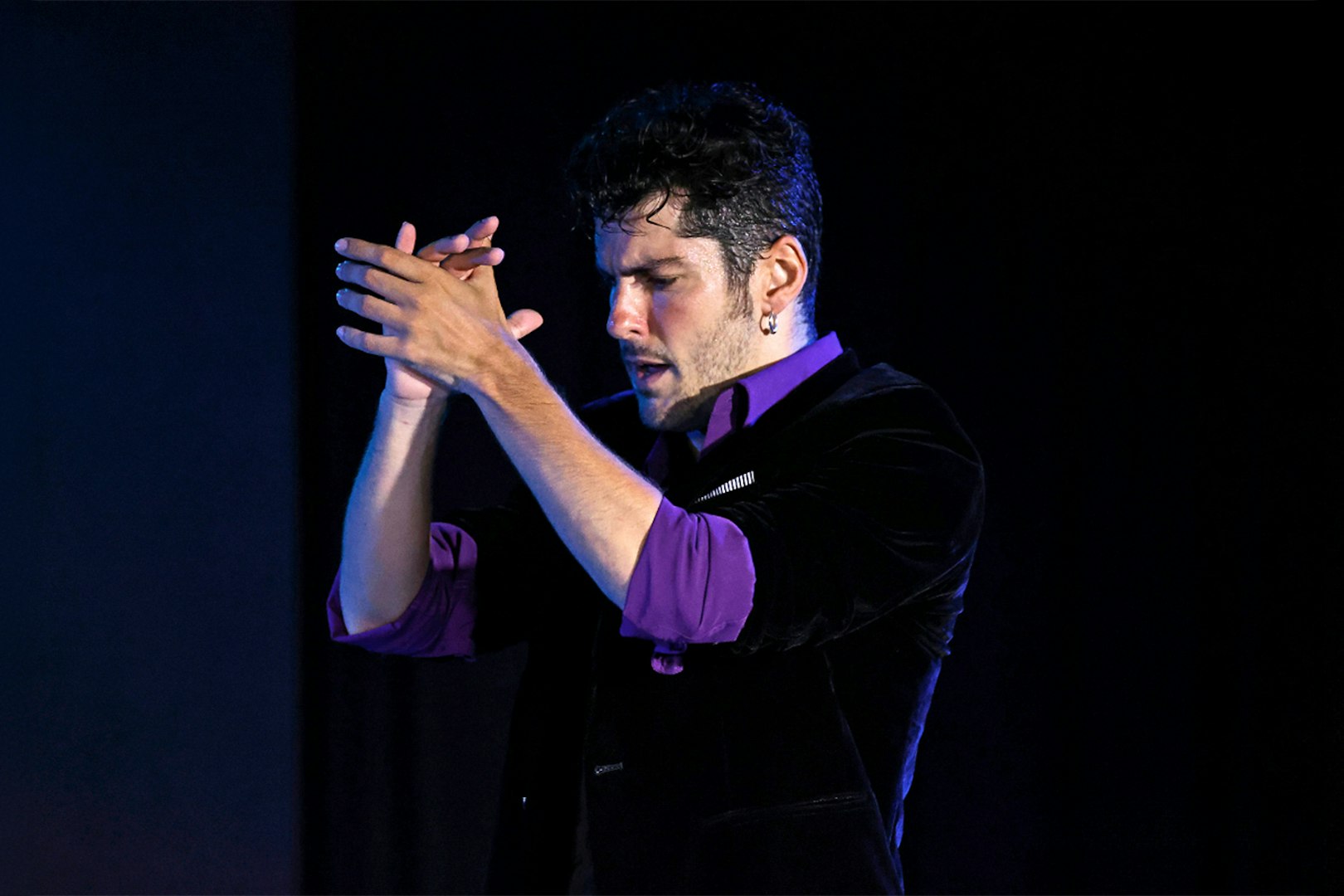 Performer clapping during Flamenco Show at Tablao Flamenco Alma.