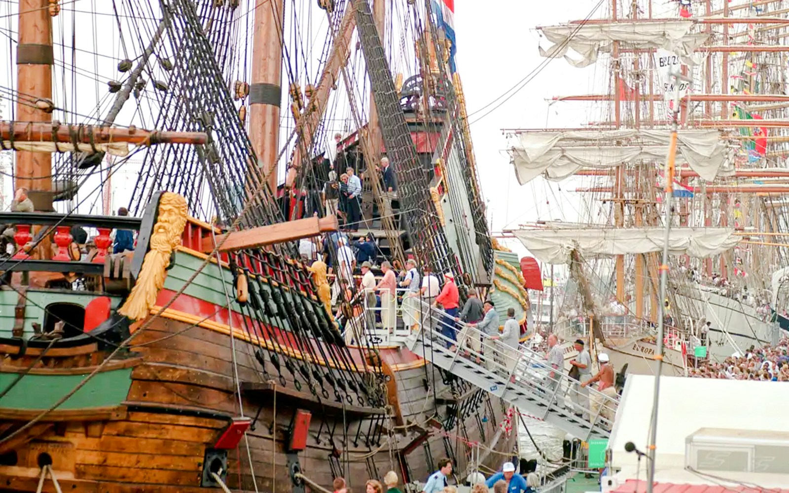 Historic ships with visitors boarding at Sail Amsterdam event.