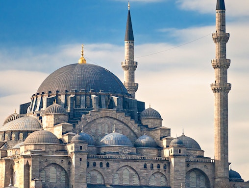 Süleymaniye Mosque with its domes and minarets under a blue sky in Istanbul.
