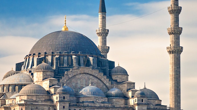 Süleymaniye Mosque with its domes and minarets under a blue sky in Istanbul.