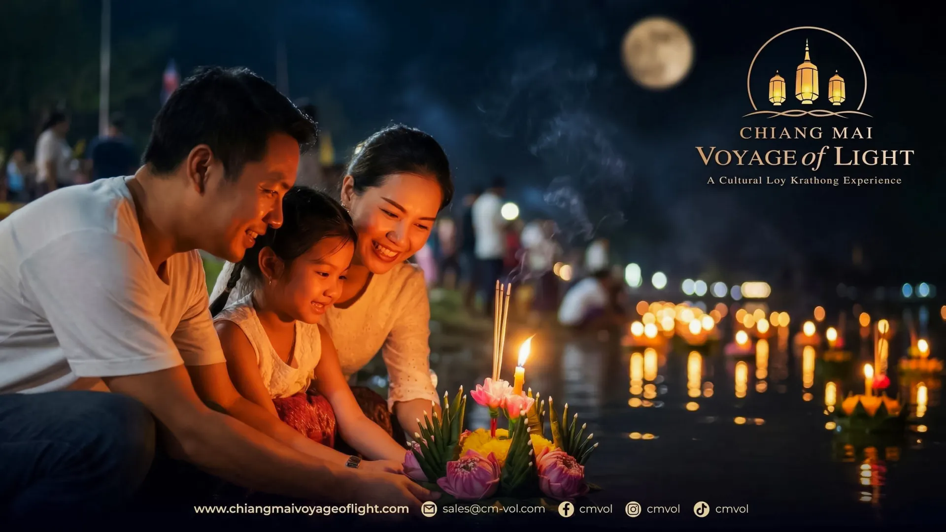 Family releasing krathong on river during Chiang Mai Voyage of Light festival.