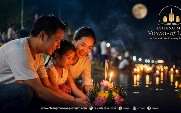 Family releasing krathong on river during Chiang Mai Voyage of Light festival.