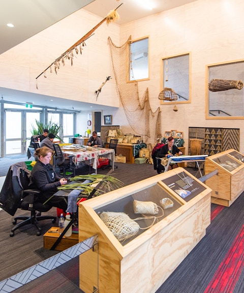 Craftsmen weaving flax at Te Puia cultural center, Rotorua, New Zealand.