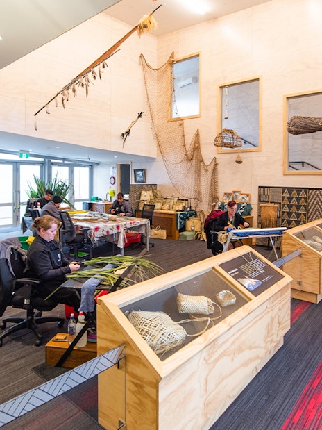 Craftsmen weaving flax at Te Puia cultural center, Rotorua, New Zealand.
