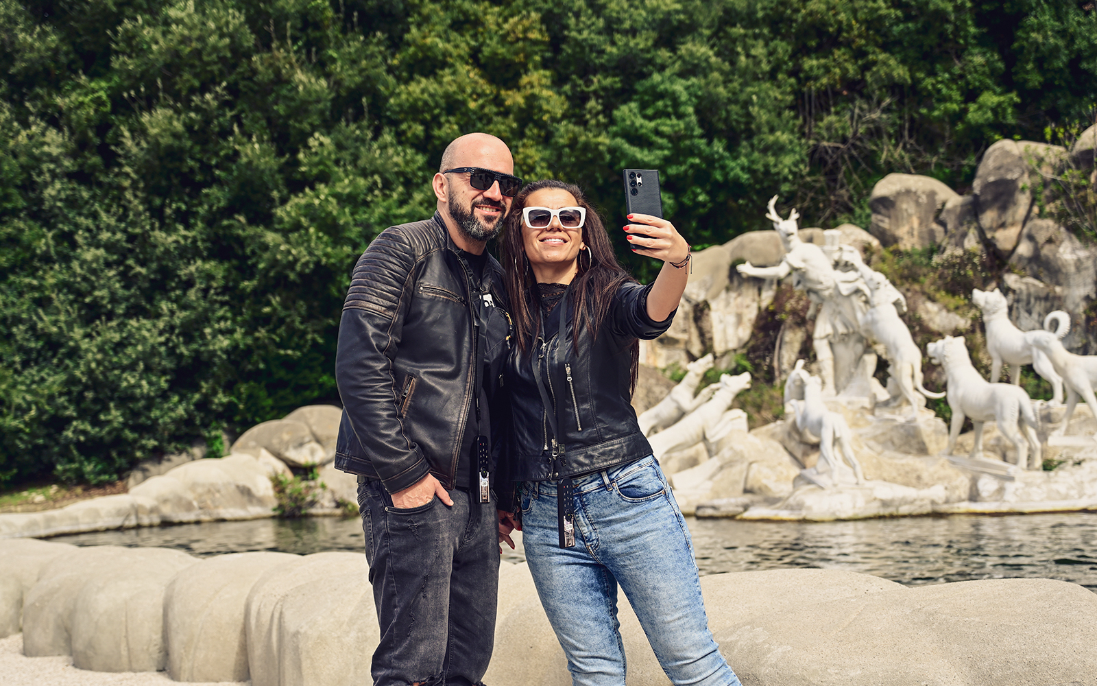 Tourists taking a selfie at the Royal Palace of Caserta fountains, Italy.