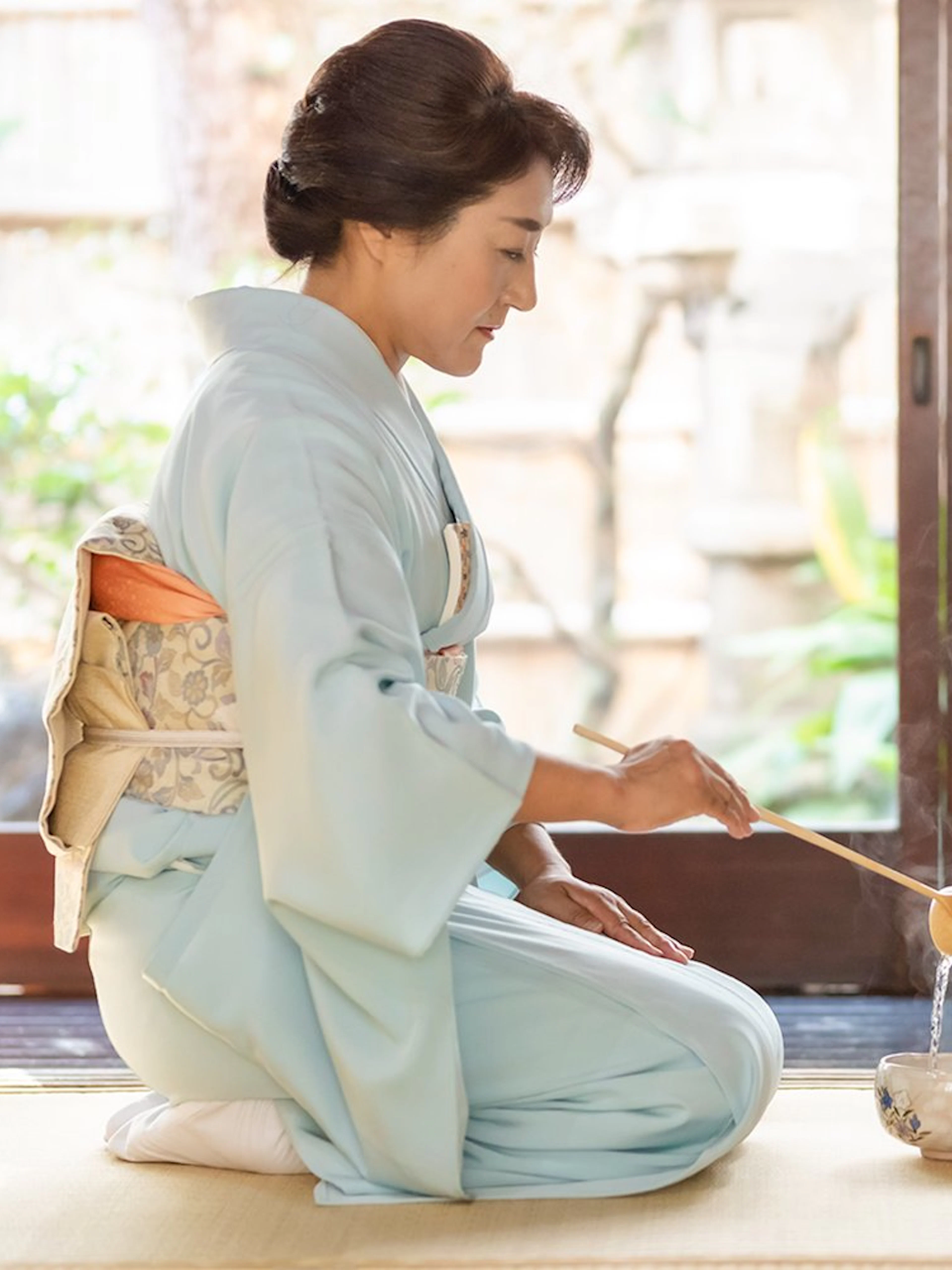Tea ceremony in traditional kimono inside historic Machiya townhouse.