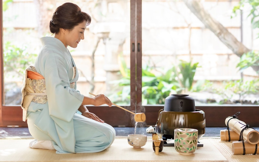 Tea ceremony in traditional kimono inside historic Machiya townhouse.