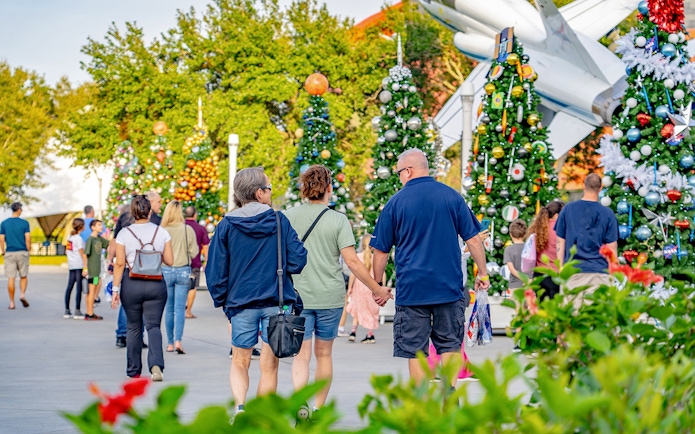 Visitors walking among decorated trees at Kennedy Space Center, Florida.