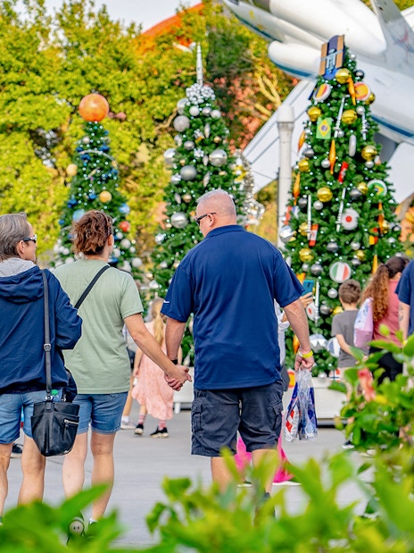Visitors walking among decorated trees at Kennedy Space Center, Florida.