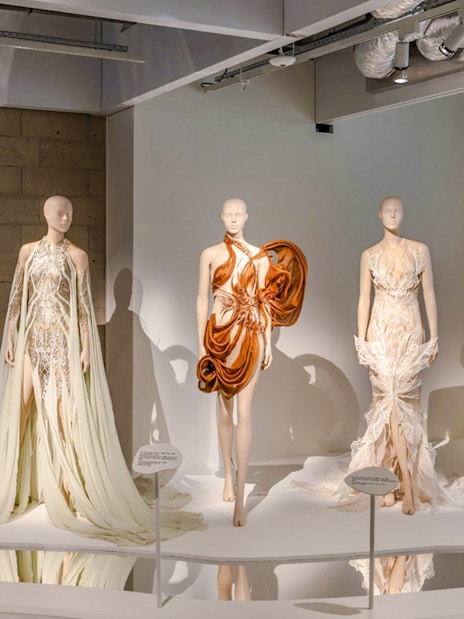 Mannequins displaying avant-garde fashion designs at ArtScience Museum exhibit.