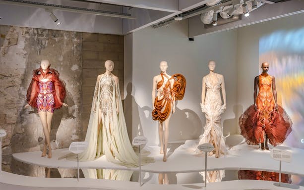 Mannequins displaying avant-garde fashion designs at ArtScience Museum exhibit.