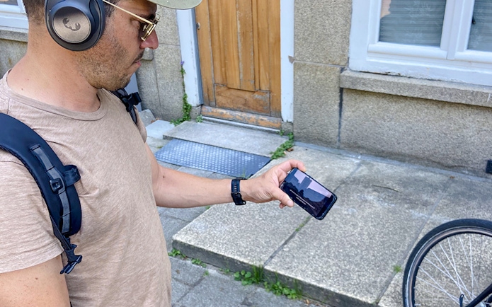 Guest using phone during Anne Frank walk in Amsterdam.