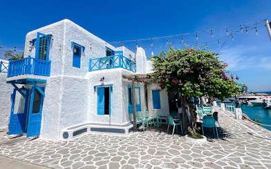 White building with blue accents by the sea, part of Da Nang Coastal Charm Half-Day Cafe Tour.