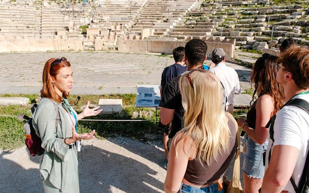 Guide leading a tour at Odeon of Herodes Atticus amphitheater, Athens.