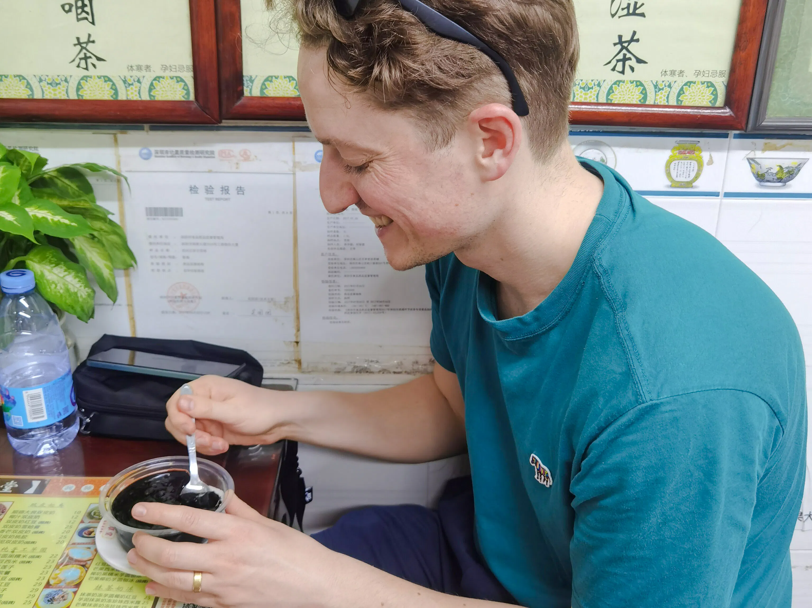 Man enjoying traditional dessert in a Shenzhen eatery.