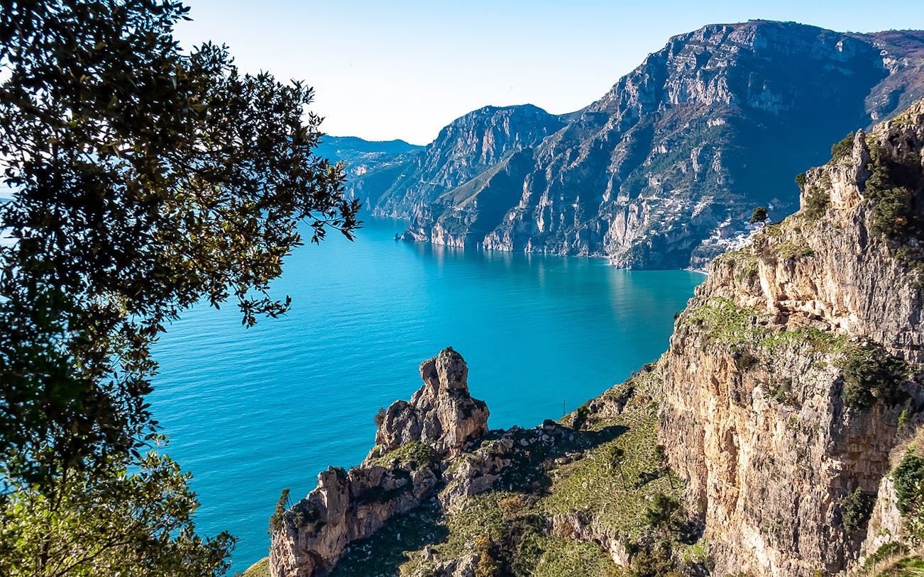 Sorrento coastline with cliffs and blue sea on a guided tour.