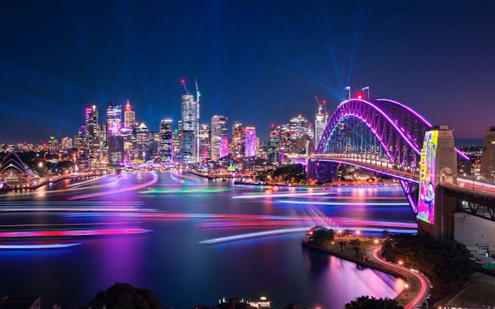 Sydney Harbour Bridge illuminated during Vivid Sydney festival on Premium Vivid Cruise.