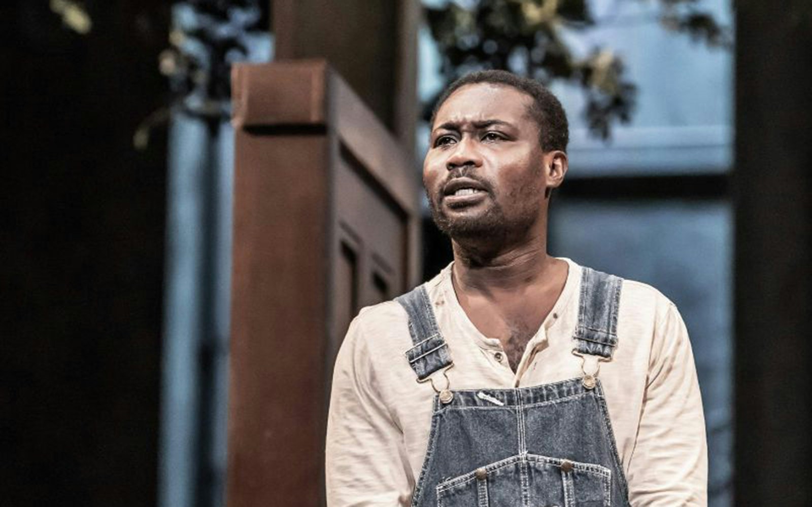 Man in overalls performing in "To Kill A Mockingbird" stage play.