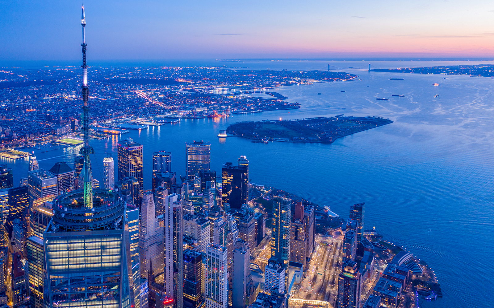 Aerial view of New York City skyline from One World Observatory at dusk.