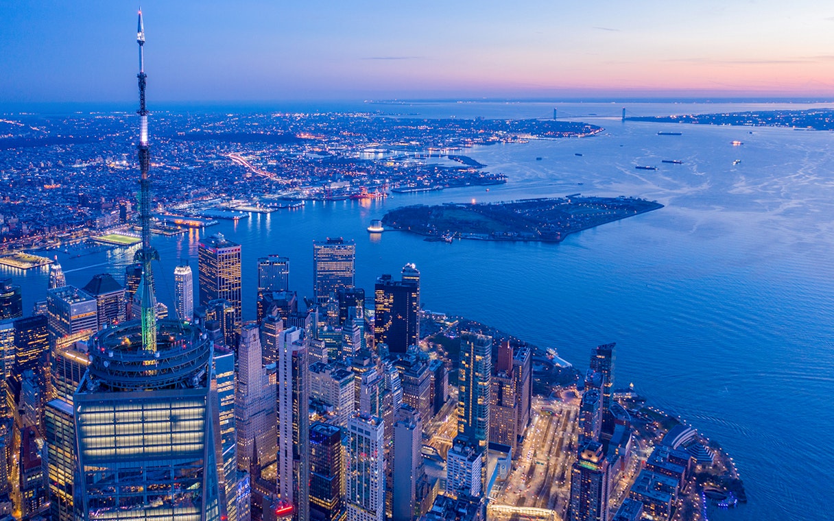 Aerial view of New York City skyline from One World Observatory at dusk.