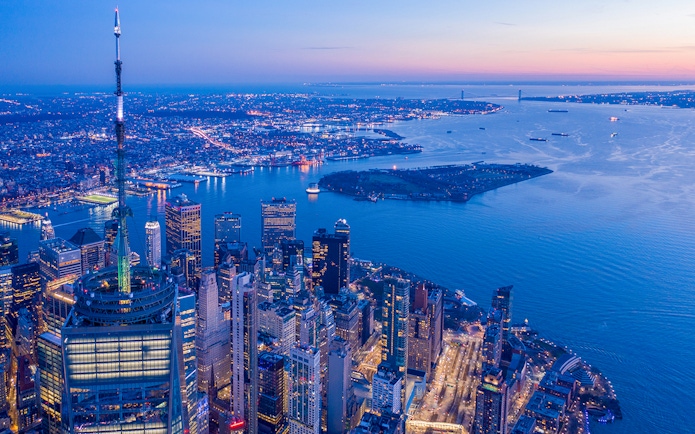 Aerial view of New York City skyline from One World Observatory at dusk.