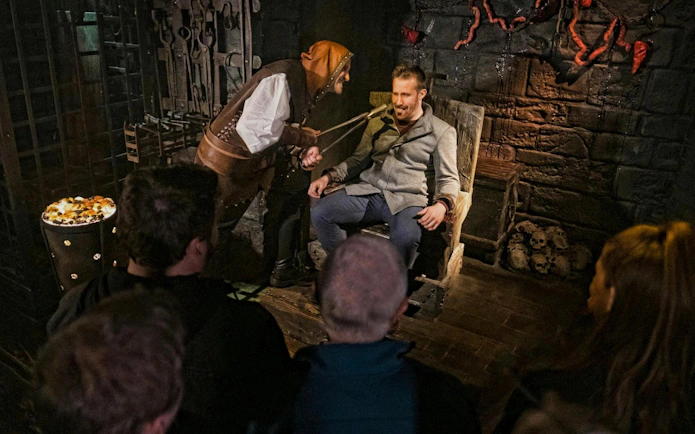 Guests experiencing an interactive scene at the London Dungeon VIP Package.