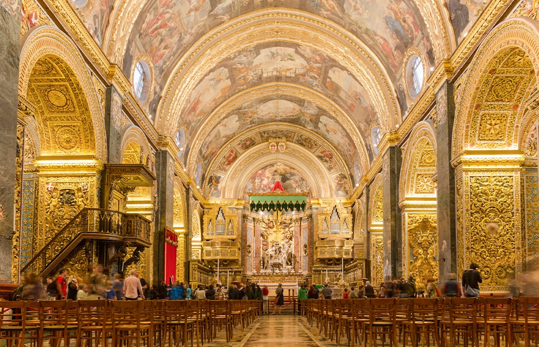 St John's Co-Cathedral interior with ornate ceiling and marble floor in Valletta, Malta.